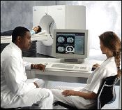 A physican and technologist view a CT scan