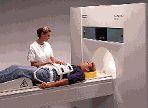 A Technologist prepares a person for an MRI scan